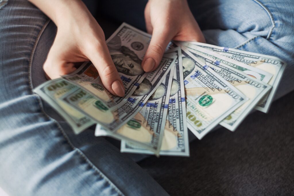Image of person holding money in Things that I wish they had taught me in school article