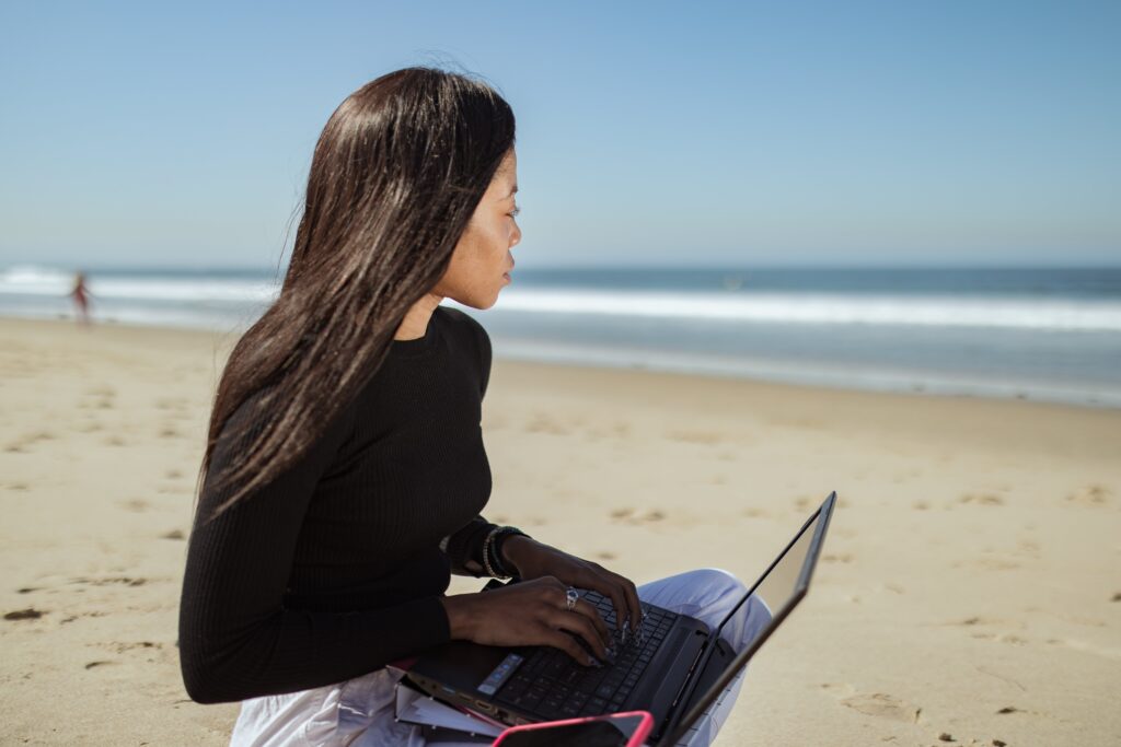 Is everyone suited or skilled to run a business image of woman on a beach with a laptop
